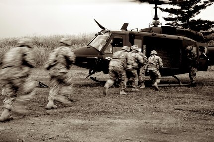 Texas National Guard Soldiers with 3rd Battalion, 141st Infantry Regiment, board a UH-1J helicopter, a variant of the UH-1J Iroquois, provided by the Japan Ground Self-Defense Force Eastern Army, 1st Division, 1st Aviation, at the heliborne tactical training exercise during Orient Shield 2011 at Kita-Fuji Training Area, Japan Oct. 13, 2011.