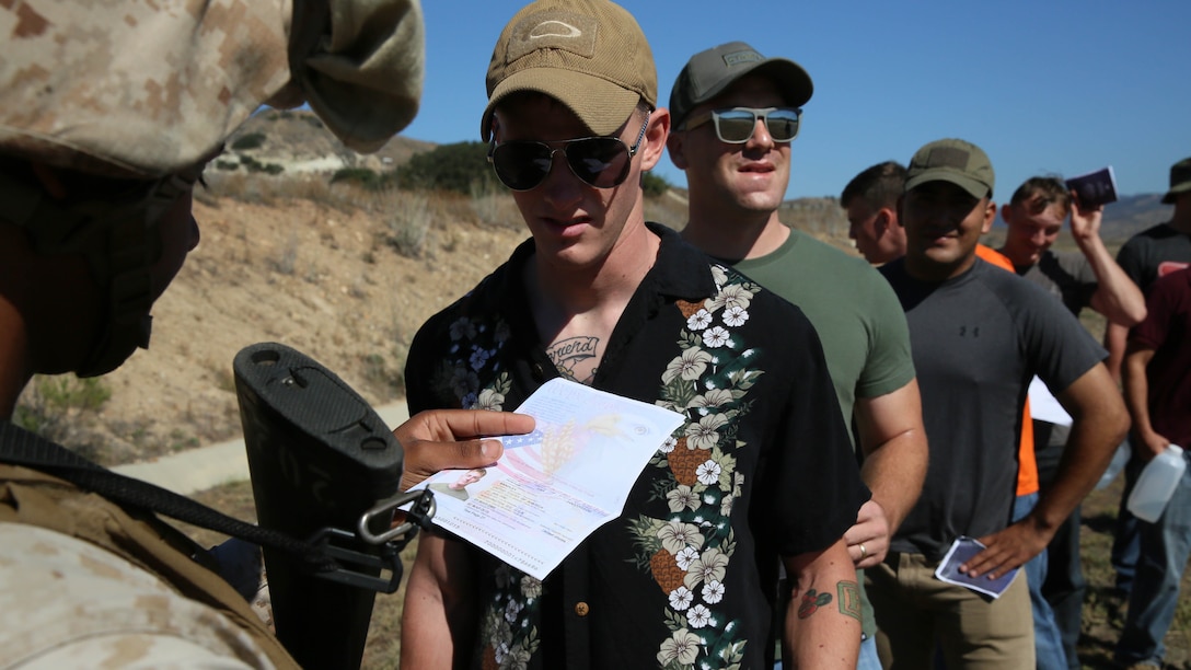 A Marine with Combat Logistics Battalion 13, the logistics combat element for the Boxer Amphibious Ready Group and 13th Marine Expeditionary Unit, checks passports and identification at the orientation station of the evacuee collection center during non-combatant evacuation operations at Marine Corps Base Camp Pendleton, California as part of as part of Composite Training Unit Exercise, Oct. 23, 2015. COMPTUEX provides the MEU ARG the opportunity to integrate naval training while also allowing focused, mission-specific training and evaluation for the Navy-Marine Corps team. 