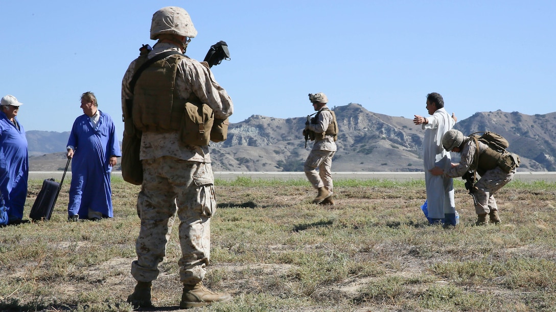 U.S. Marines with the Boxer Amphibious Ready Group and 13th Marine Expeditionary Unit search role-players for weapons and contraband during non-combatant evacuation operations at Marine Corps Base Camp Pendleton, California as part of Composite Training Unit Exercise, Oct. 23, 2015. COMPTUEX provides the MEU ARG the opportunity to integrate naval training while also allowing focused, mission-specific training and evaluation for the Navy-Marine Corps team. 