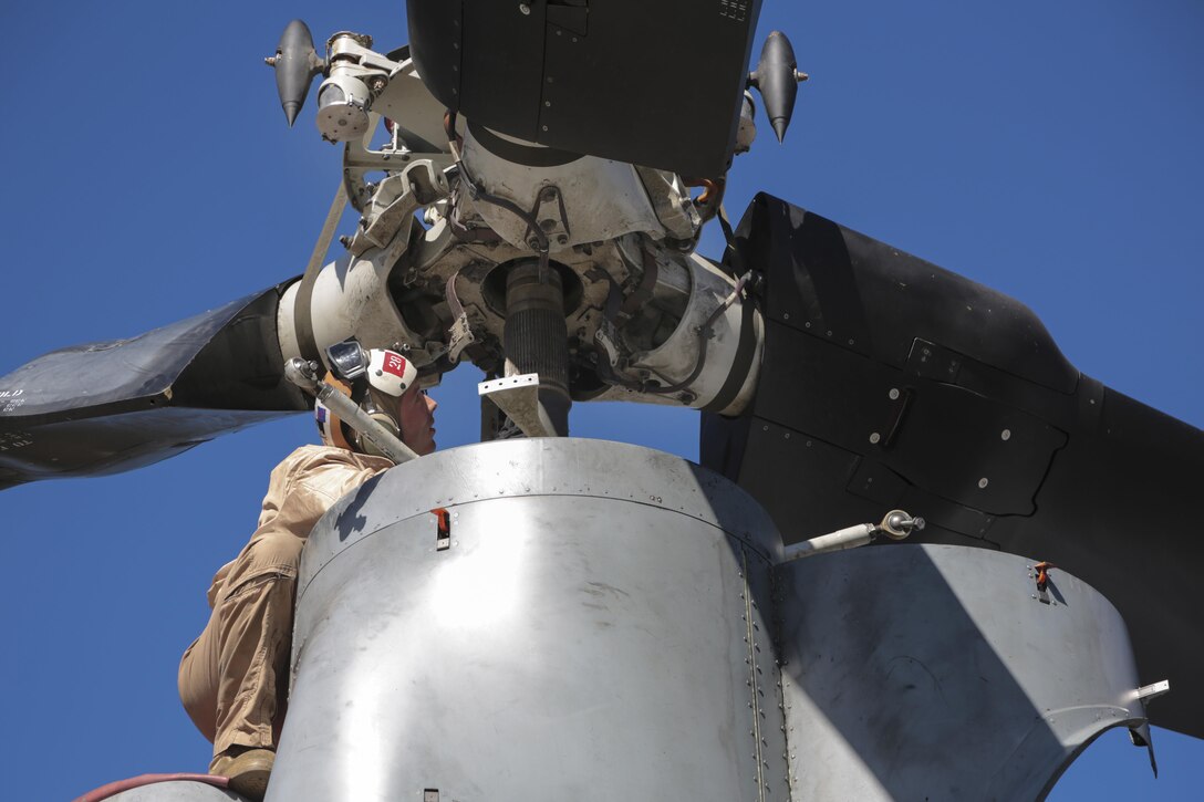 U.S. Marine Corps Sgt. Ryan Boele reinstalls a prop rotor hub on an MV-22B Osprey aircraft during Mountain Exercise 6-15 at Mountain West Aviation, South Lake Tahoe, Calif., Oct. 26, 2015. Boele is a mechanic assigned to Marine Medium Tiltrotor Squadron 163, Marine Aircraft Group 16, 3rd Marine Aircraft Wing. U.S. Marine Corps photo by Cpl. Allison J. Herman