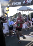 A Pennsylvania National Guard runner crosses the finish line of the 27th Army Ten-Miler in Arlington, Va., Oct. 9, 2011. More than 1,700 Guard runners participated in the event this year.