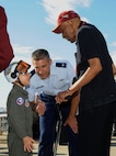 Samuel Isler (left), and Col. Matthew Isler, 12th Flying Training Wing commander, speaks with Dr. Granville Coggs (right), Documented Original Tuskegee Airman, during the 2015 Joint Base San Antonio Air Show and Open House Oct. 31, 2015 at JBSA-Randolph.  Coggs was an honored guest at the air show which allowed the Air Force to display the capabilities of our aircraft to the American taxpayer through aerial demonstrations and static display.  Randolph’s air show allowed attendees to get up close and personal to see some of the equipment and aircraft used by the U.S military today.