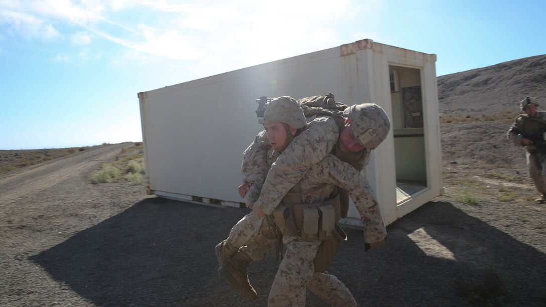 Lance Cpl. Samuel Eversole, an infantryman with Assault Amphibian Vehicle Platoon, Company E, Battalion Landing Team 2/1, the ground combat element for the Boxer Amphibious Ready Group and 13th Marine Expeditionary Unit, lifts a simulated casualty to carry him to safety during an amphibious assault as part of Composite Training Unit Exercise, Oct. 23, 2015. COMPTUEX provides the MEU ARG the opportunity to integrate naval training while also allowing focused, mission-specific training and evaluation for the Navy-Marine Corps team. 