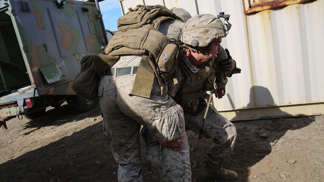 Lance Cpl. Samuel Eversole, an infantryman with Assault Amphibian Vehicle Platoon, Company E, Battalion Landing Team 2/1, the ground combat element for the Boxer Amphibious Ready Group and 13th Marine Expeditionary Unit, lifts a simulated casualty to carry him to safety during an amphibious assault as part of Composite Training Unit Exercise, Oct. 23, 2015. COMPTUEX provides the MEU ARG the opportunity to integrate naval training while also allowing focused, mission-specific training and evaluation for the Navy-Marine Corps team. 