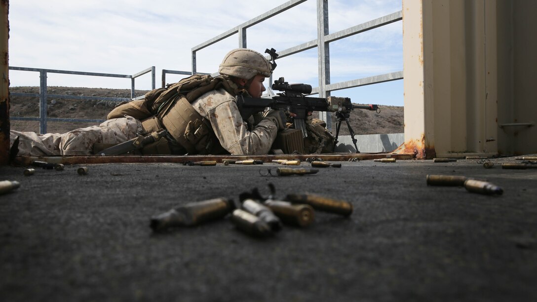 Lance Cpl. Micah Willis, an infantryman with Assault Amphibian Vehicle Platoon, Company E, Battalion Landing Team 2/1, the ground combat element for the Boxer Amphibious Ready Group and 13th Marine Expeditionary Unit, provides rear security from an over watch position during an amphibious assault as part of Composite Training Unit Exercise, Oct. 23, 2015. COMPTUEX provides the ARG/MEU the opportunity to integrate naval training while also allowing focused, mission-specific training and evaluation for the Navy-Marine Corps team. 