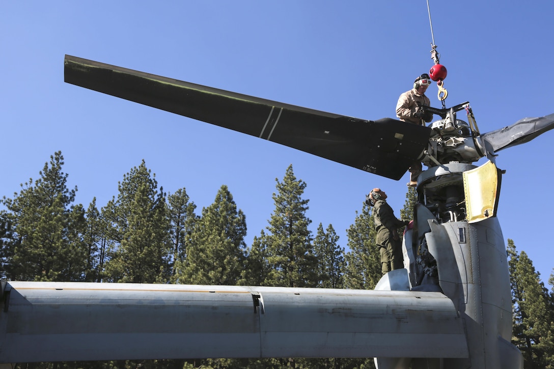 Marine Corps Cpl. Gustavo Ordinola, left, and Sgt. Ryan Boele reinstall a prop rotor hub on an MV-22B Osprey aircraft during Mountain Exercise 6-15 at Mountain West Aviation, South Lake Tahoe, Calif., Oct. 26, 2015. Ordinola and Boele are mechanics assigned to Marine Medium Tiltrotor Squadron 163, Marine Aircraft Group 16, 3rd Marine Aircraft Wing. U.S. Marine Corps photo by Cpl. Allison J. Herman