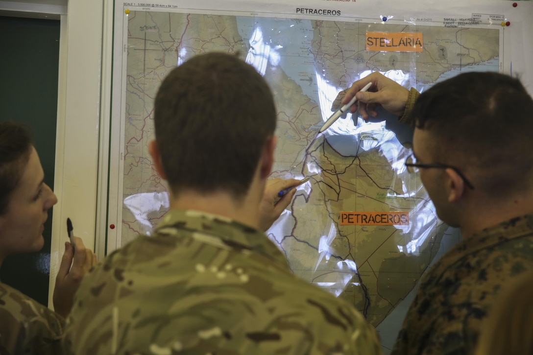 U.S. Marines with 2nd Intelligence Battalion and British soldiers search for a location on a map during Exercise Phoenix Odyssey II in Edinburgh, U.K., Oct. 27, 2015. The British and U.S. are collaborating for the second consecutive year in order to enhance joint intelligence operations. (U.S. Marine Corps photo by Cpl. Lucas Hopkins/Released)