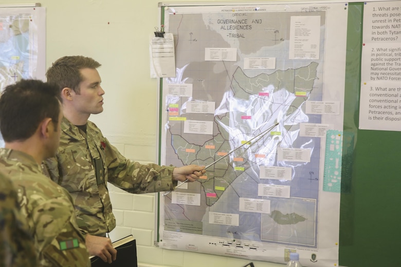 A British soldier points at a location on a map while briefing U.S. Marines with 2nd Intelligence Battalion and other soldiers during Exercise Phoenix Odyssey II in Edinburgh, U.K., Oct. 27, 2015. The two-week exercise is built to strengthen intelligence capabilities between the two nations. (U.S. Marine Corps photo by Cpl. Lucas Hopkins/Released)