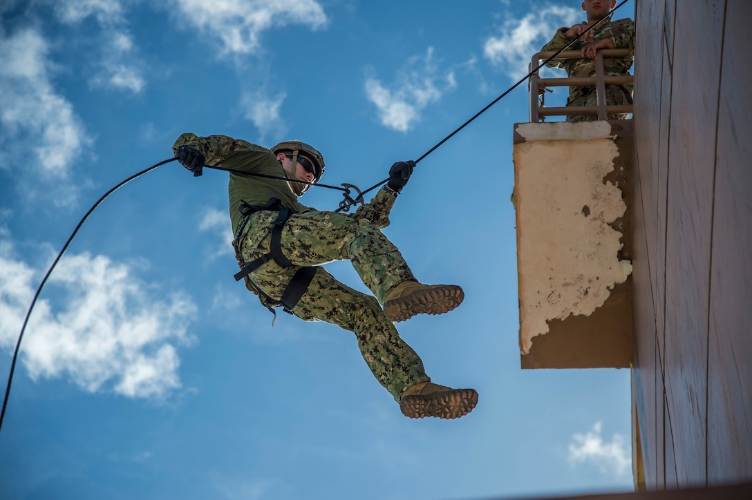 Sailors conduct helicopter rope suspension technique operations on Naval Base Guam, Oct. 29, 2015. The sailors are explosive ordnance disposal (EOD) technicians assigned to EOD Mobile Unit 5 and EOD Mobile Unit 6. U.S. Navy photo by Petty Officer 2nd Class Daniel Rolston