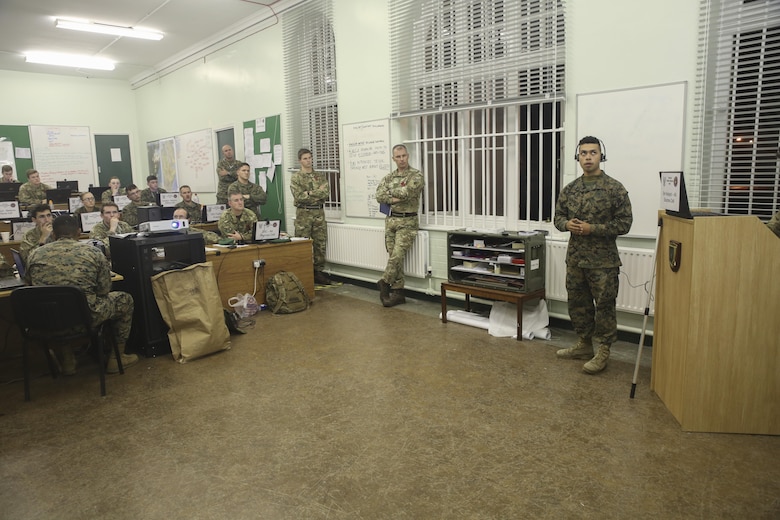 U.S. Marine Pfc. Jahaziel Ariasbosa, right, an intelligence specialist with 2nd Intelligence Battalion, gives a brief other Marines and British soldiers during Exercise Phoenix Odyssey II in Edinburgh, U.K., Oct. 28, 2015. The exercise is designed to increase the intelligence capabilities of both nations while operating in a joint environment. (U.S. Marine Corps photo by Cpl. Lucas Hopkins/Released)