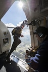 Manny Garcia, 25th Air Force audio visual specialist, films Staff Sgt. Mike Koch, U.S. Army Parachute Team “Golden Knights” demonstration parachutist, as he jumps out of the Army Golden Knight’s aircraft during the Joint Base San Antonio Air Show and Open House Nov. 1, 2015, at JBSA-Randolph. The Golden Knights have a threefold mission: recruit the next generation of Soldiers, support public outreach through conducting tandem parachute jumps and compete against the world’s best skydivers at national and international parachuting competitions.