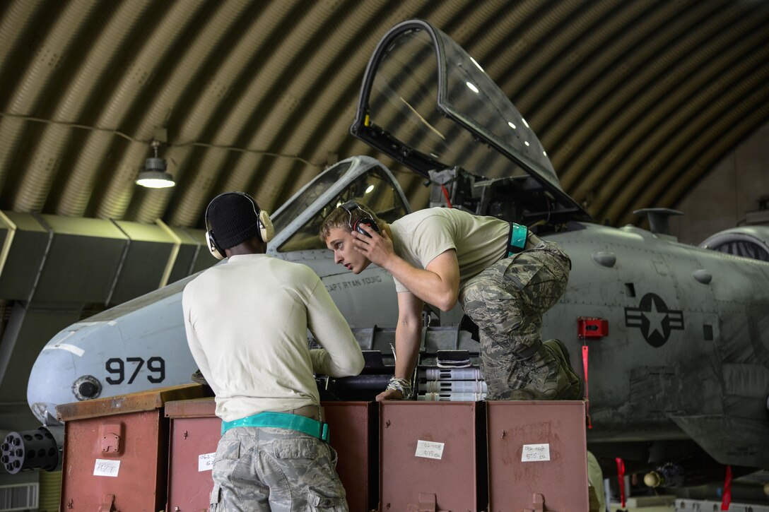 Senior Airman Kameron Whitener and Airman 1st Class Brandon Jones, 25th Aircraft Maintenance Unit weapons load crew team members, prepare to load 30 millimeter rounds onto an A-10 Thunderbolt II during the Vigilant Ace 16 exercise on Osan Air Base, Republic of Korea, Nov. 1, 2015. Each team has three Airmen who are all responsible for different portions of the load. The one-man is the supervisor, the two-man is responsible for tools and aircraft preparation and the three-man is responsible for driving the jammer and munitions preparation. Without each member, the crews would not be able to properly load munitions in the safest way possible. (U.S. Air Force photo/Senior Airman Kristin High)