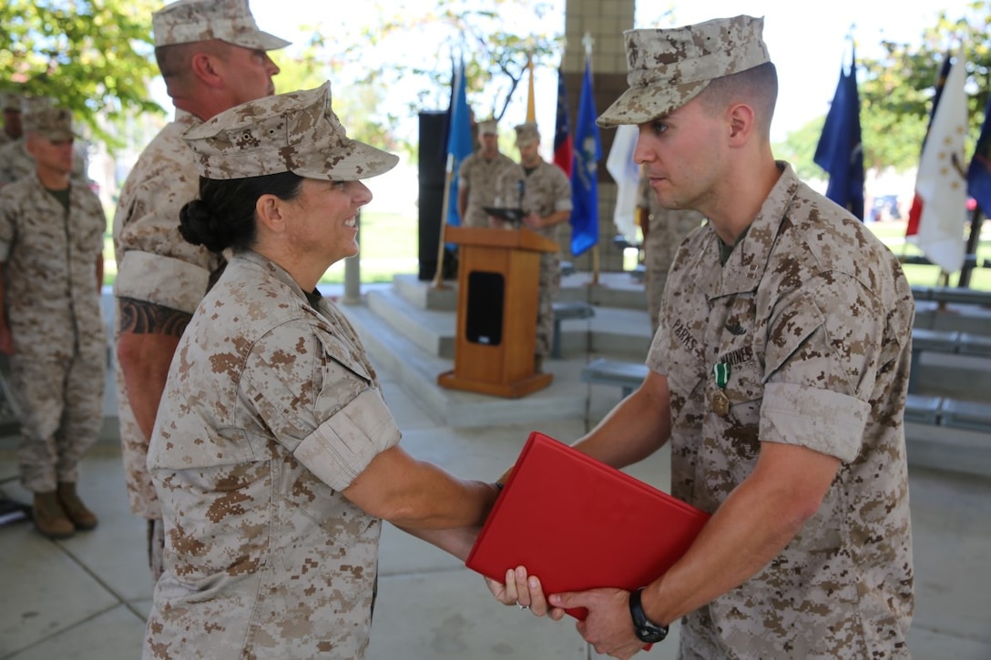 Captain Elliot Parks is congratulated by Col. Roberta L. Shea during the I Marine Expeditionary Force Headquarters Group change of command ceremony aboard Marine Corps Base Camp Pendleton, Calif., Oct. 29, 2015. During his time, Parks commanded more than 1,000 Marines and Sailors.