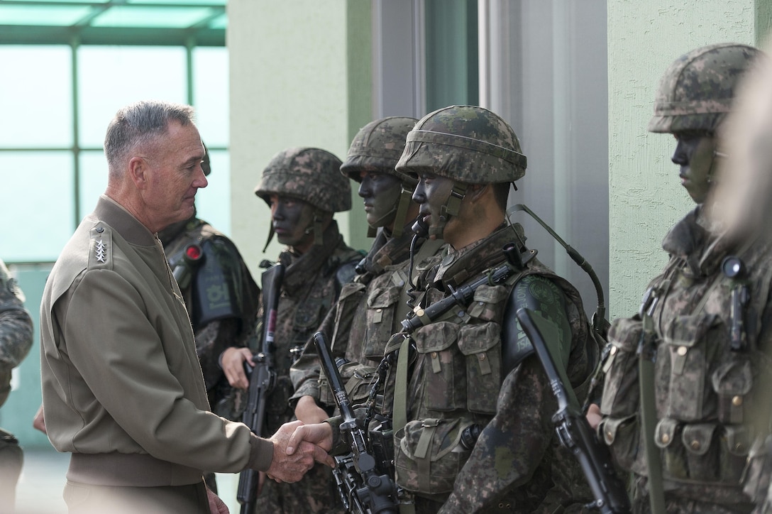 U.S. Marine Corps Gen. Joseph F. Dunford Jr., chairman of the Joint Chiefs of Staff, shakes hands with a South Korean soldier during a trip to the Demilitarized Zone, Nov. 2, 2015. DoD photo by U.S. Navy Petty Officer 2nd Class Dominique A. Pineiro