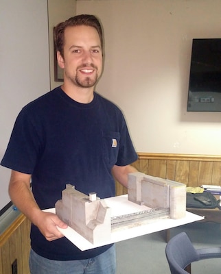 Greg Turko, civil engineer with the Pittsburg District, stands with their new 3D Emsworth Lock model that will be used for training new employees on the process of bulkhead installation.