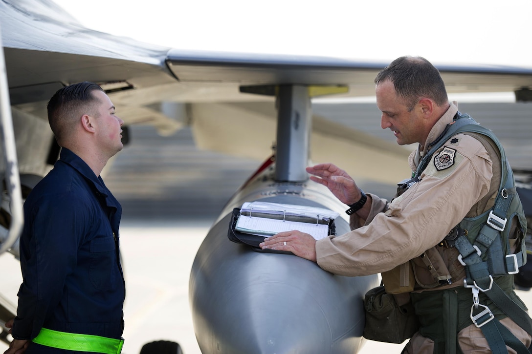 U.S. Air Force Senior Airman Zachary Szalay, left, talks with U.S. Air Force Lt. Col. Michael Meyer before a sortie mission on Bagram Airfield, Afghanistan, Oct. 30, 2015. Szalay is a crew chief assigned to the 455th Expeditionary Aircraft Maintenance Squadron and Myers is commander, 421st Expeditionary Fighter Squadron. U.S. Air Force photo by Tech. Sgt. Robert Cloys