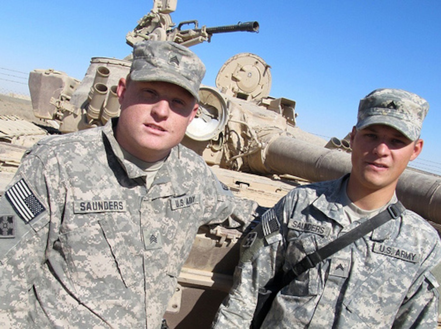 Army National Guard Sgt. Jonas Saunders stands beside his twin brother, Army National Guard Cpl. Jason Saunders, at Joint Base Balad, Iraq, Oct. 21, 2011. The brothers, 25-year-old natives of Barbourville, Ky., are serving on their second deployment to Iraq together.