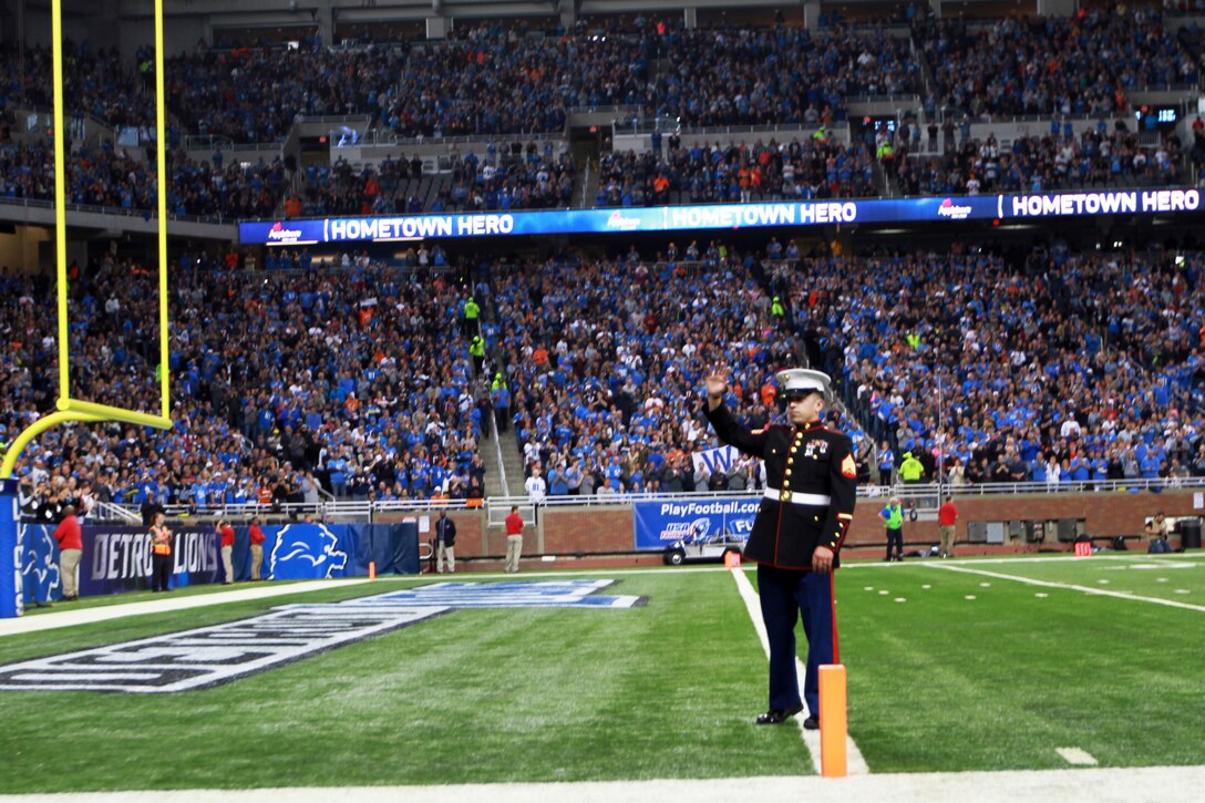 U.S. Marine Corps Sgt. Benjamin J. Annarino waves to more than 60,000 cheering fans during a Detroit Lions football game at Ford Field in Detroit, Oct. 20, 2015. Annarino was honored as the game’s Hometown Hero during a break in play in the third quarter. Annarino is a canvassing recruiter for Recruiting Station Detroit and a Livonia, Mich., native. U.S. Marine Corps photo by Sgt. J. R. Heins