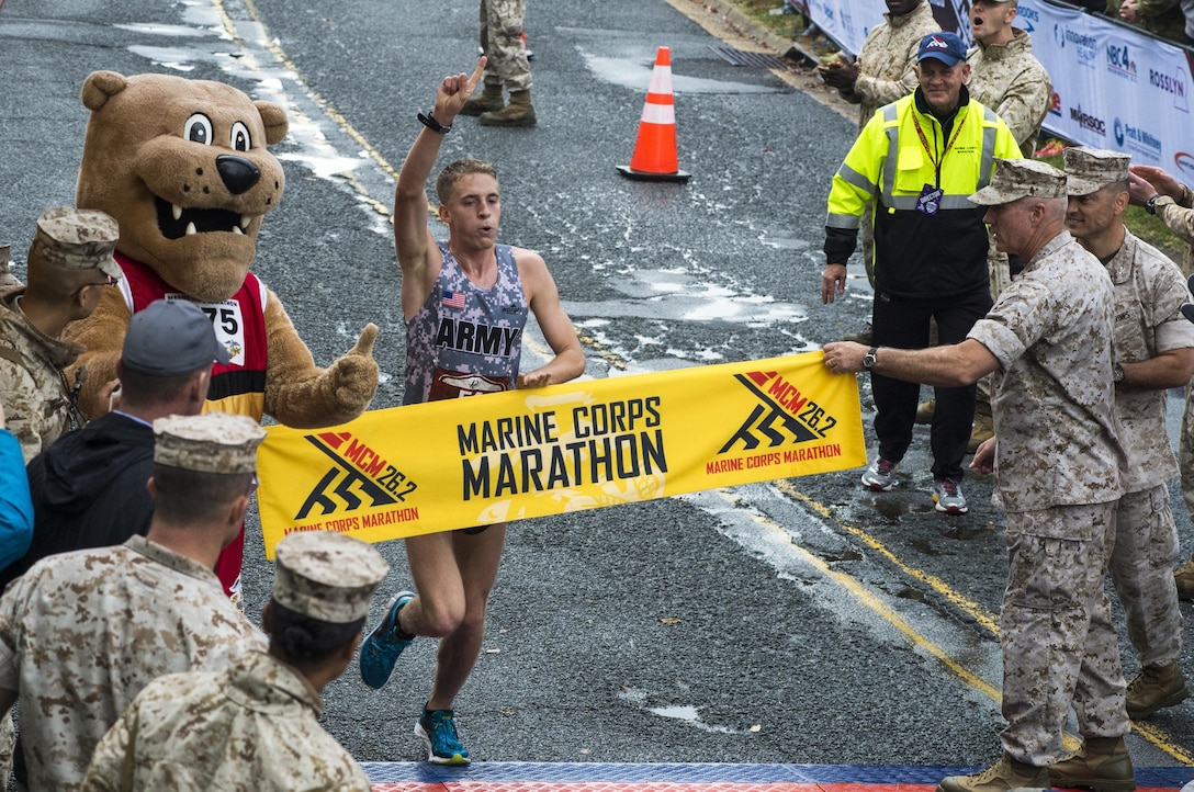 Overall winner of the 40th Marine Corps Marathon, U.S. Army Lt. Trevor Lafontaine, runs through the finish line of his first marathon at 2:24:25 in Arlington, Va., Oct. 25, 2015. Also known as "The People's Marathon," the 26.2 mile race drew roughly 30,000 participants to promote physical fitness, generate goodwill in the community, and showcase the organizational skills of the Marine Corps. (U.S. Marine Corps photo by Staff Sgt. Sarah R. Hickory/Released)