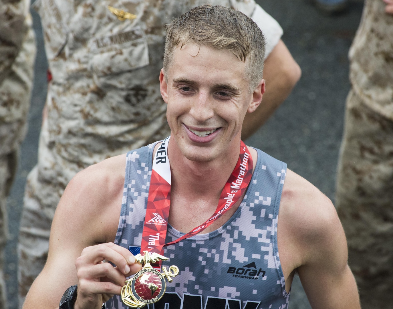 Overall winner of the 40th Marine Corps Marathon, 22 year old U.S. Army Lt. Trevor Lafontaine, from Cornwall, N.Y., smiles and holds up his medal after completing his first marathon at 2:24:25 in Arlington, Va., Oct. 25, 2015. Also known as "The People's Marathon," the 26.2 mile race drew roughly 30,000 participants to promote physical fitness, generate goodwill in the community, and showcase the organizational skills of the Marine Corps. (U.S. Marine Corps photo by Staff Sgt. Sarah R. Hickory/Released)