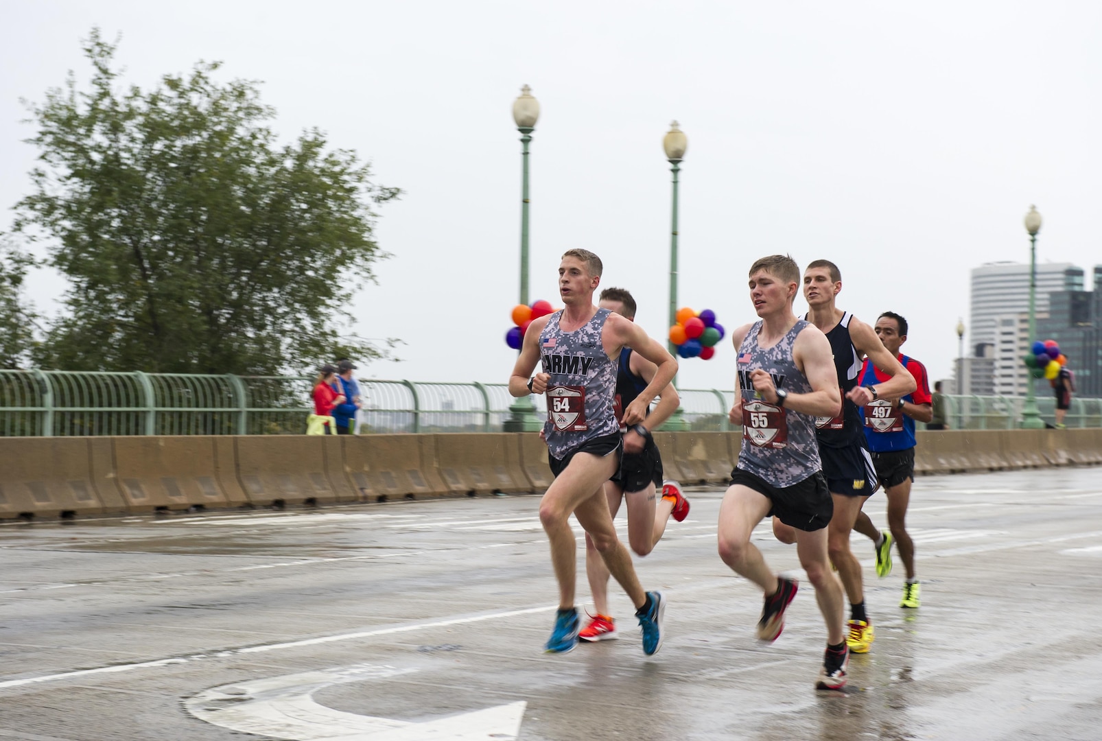 Two members of the U.S. Army Running Team, Trevor LaFontaine (#54) from Cornwall, N.Y., and Daniel Schlich (#55), from Saint Robert, Mo., cross the Francis Scott Key Bridge during the 40th Marine Corps Marathon near the 4-mile mark from Arlington, Va. into Georgetown in Washington, D.C., Oct. 25, 2015. LaFontaine, participating in his first marathon, went on take the first place male and overall win with a finish time of 2:24:25. Also known as "The People's Marathon," the 26.2 mile race drew roughly 30,000 participants to promote physical fitness, generate goodwill in the community, and showcase the organizational skills of the Marine Corps. (U.S. Marine Corps photo by Kathy Reesey/Released)