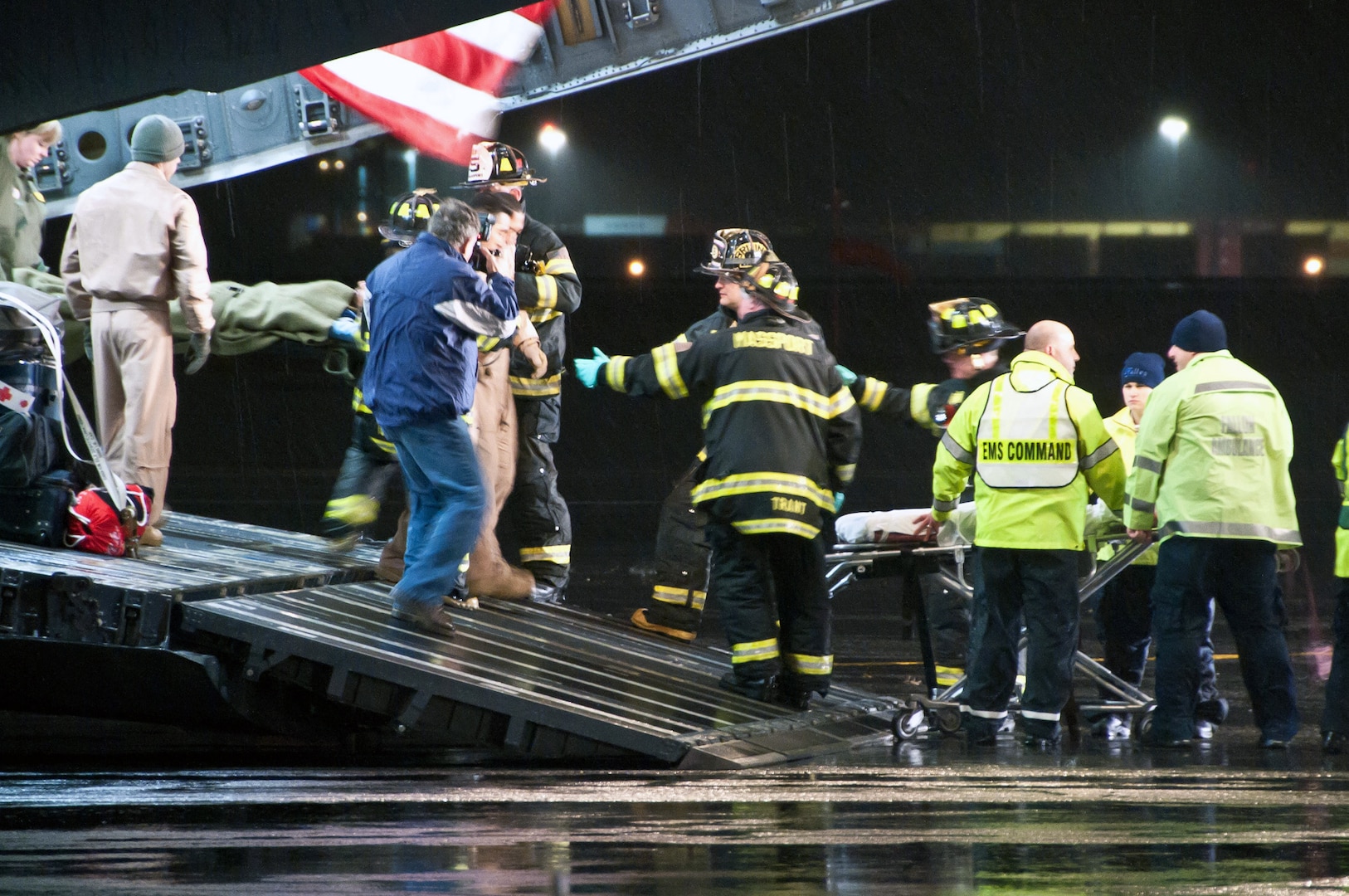 Air Force aeromedical evacuation crews, along with local emergency medical personnel, assist Libyan fighters off a C-17 Globemaster III military transport aircraft Oct. 29, 2011, at Boston Logan Airport, Mass. At the request of the Department of State and directed by the Secretary of Defense Leon Panetta, Air Force and Air National Guard crews transported 22 wounded Libyans to Spaulding Rehabilitation Hospital in Salem, Mass.