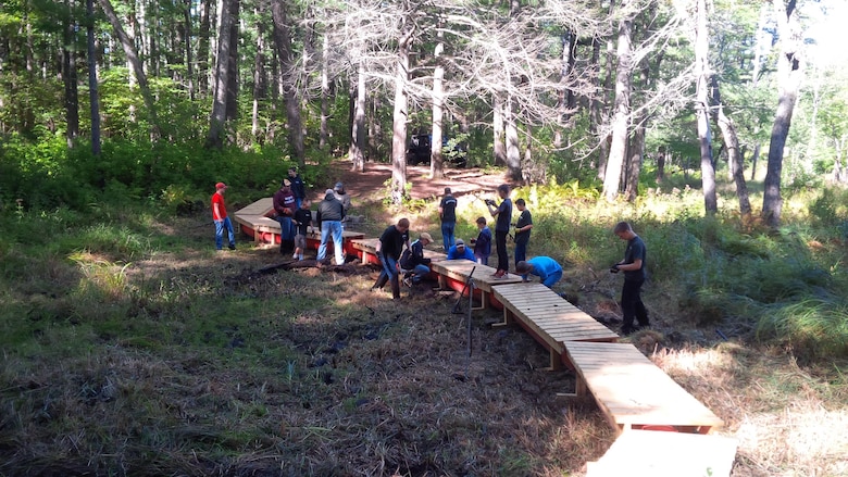 Eagle Scout Tobias Nash and his team construct a floating walkway at Hodges Village Dam in Massachusetts on September 24, 2015.