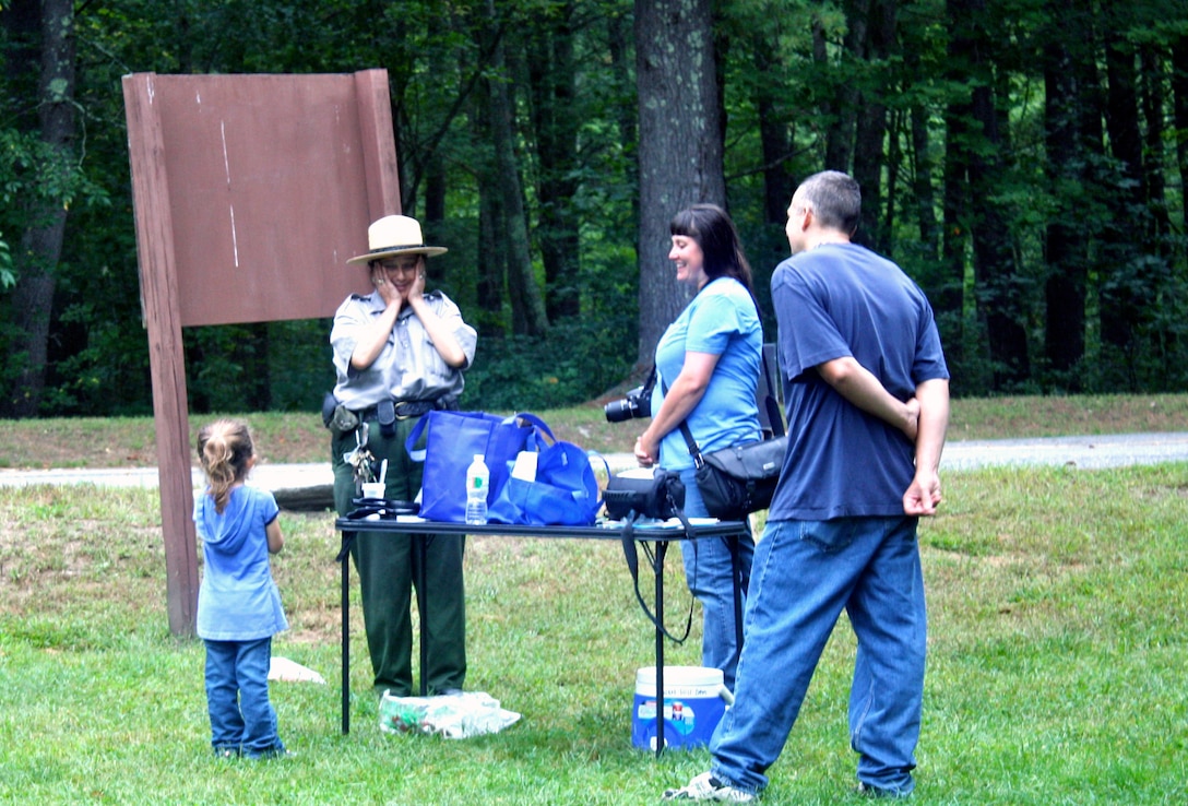 Park Ranger Viola Bramel shares the excitement of a young visitor before the story walk at West Hill Dam, Massachusetts on September 13, 2015.