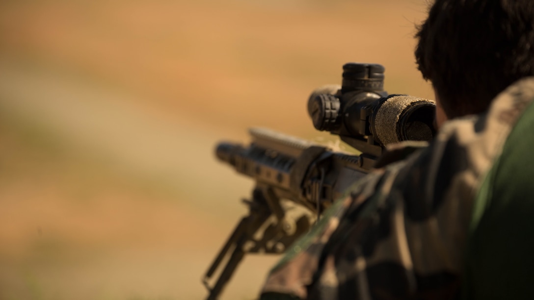 A Marine with Company C, 1st Marine Raider Battalion, U.S. Marine Corps Forces, Special Operations Command fires at distant, static targets during a Company Collective Exercise aboard Marine Corps Base Camp Pendleton, Calif., Oct. 7, 2015. Marine Special Operations Company C spent the first phase of their three-phase Company Collective Exercise practicing Foreign Internal Defense aboard Marine Corps Base Camp Pendleton, Calif., Oct. 5-8.