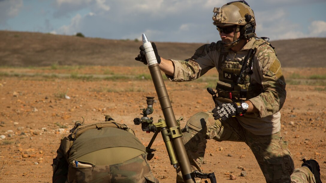 A U.S. Air Force Pararescue Jumper prepares to fire a 60 mm mortar round during a Company Collective Exercise aboard Marine Corps Base Camp Pendleton, Calif., Oct. 7, 2015. Marine Special Operations Company C, 1st Marine Raider Battalion, U.S. Marine Corps Forces, Special Operations Command spent the first phase of their three-phase Company Collective Exercise practicing Foreign Internal Defense aboard Marine Corps Base Camp Pendleton, Calif., Oct. 5-8.