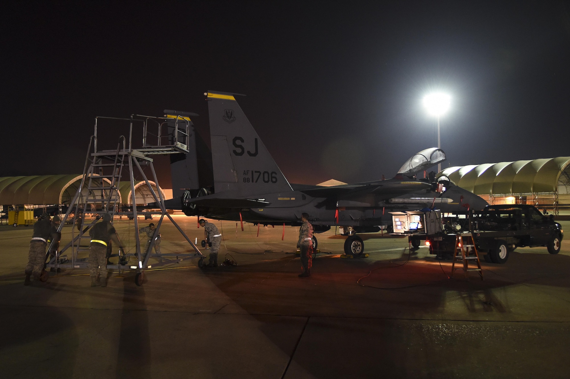 Airmen assigned to the 16th Electronic Warfare Squadron, Eglin Air Force Base, Florida, move a stand into position behind an F-15E Strike Eagle during Combat Shield, Oct. 20, 2015, at Seymour Johnson Air Force Base, North Carolina. Every year, members of the squadron evaluate the EW systems of all functional combat airframes within Air Combat Command in accordance with the Combat Shield program. (U.S. Air Force photo/Senior Airman Aaron J. Jenne)