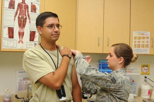 Senior Airman Sheena Boyd, a nurse assigned to the 910th Medical Squadron, administers a flu shot to an airman assigned to the 910th Airlift Wing, here, Oct. 3, 2015. It is an annual requirement for Department of Defense military personnel to receive the flu shot to help ensure their medical readiness to deploy and carry out missions anywhere around the globe. (U.S. Air Force photo/Staff Sgt. Rachel Kocin)