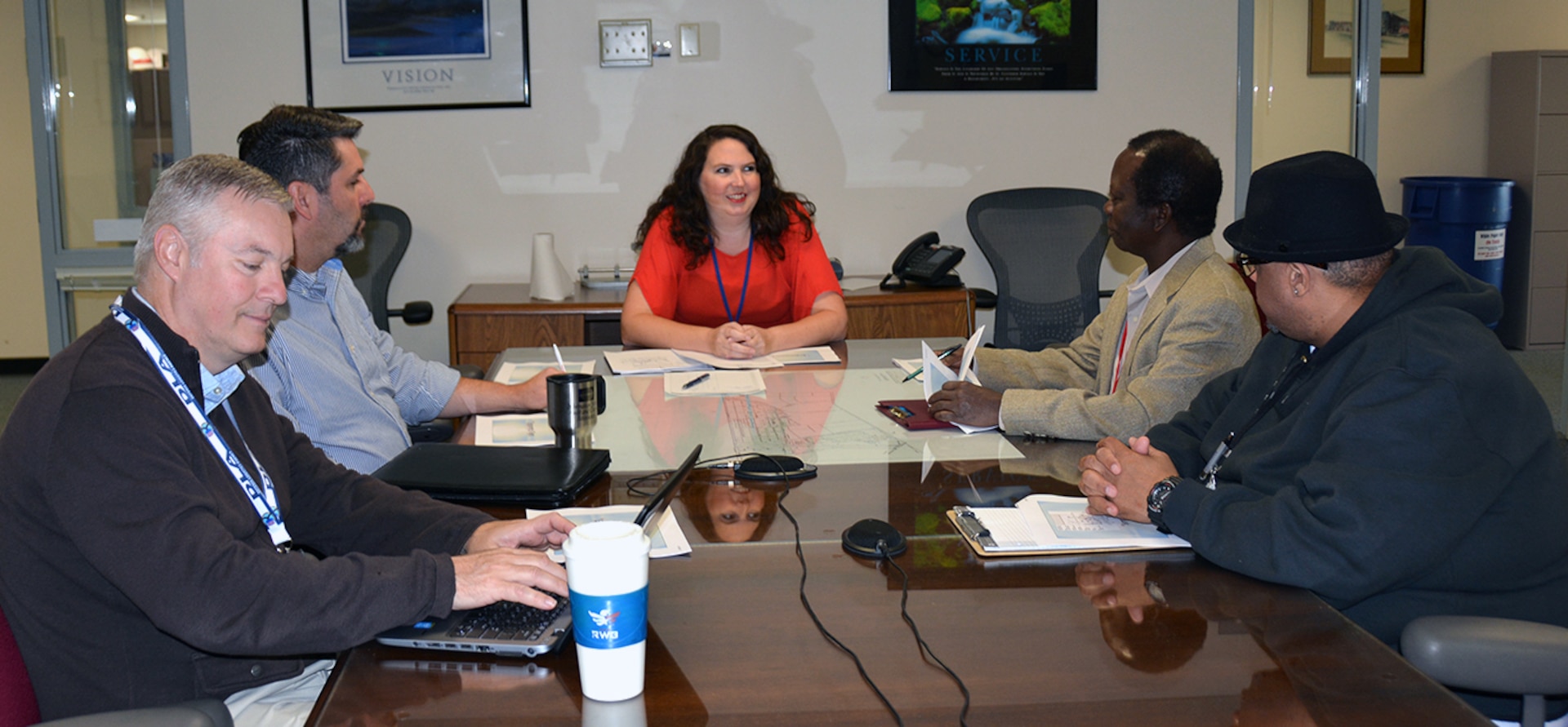 Crystal Pauley, Defense Logistics Agency Installation Support at Richmond’s ergonomics program manager, talks with her team of volunteers  (from left to right, Martin Steiner, Matthew Ritter, Tim Longe and Quinton Montaque Jr), before they head out and conduct ergonomic evaluations for employees on Defense Supply Center Richmond, Virginia, Oct. 20, 2015.