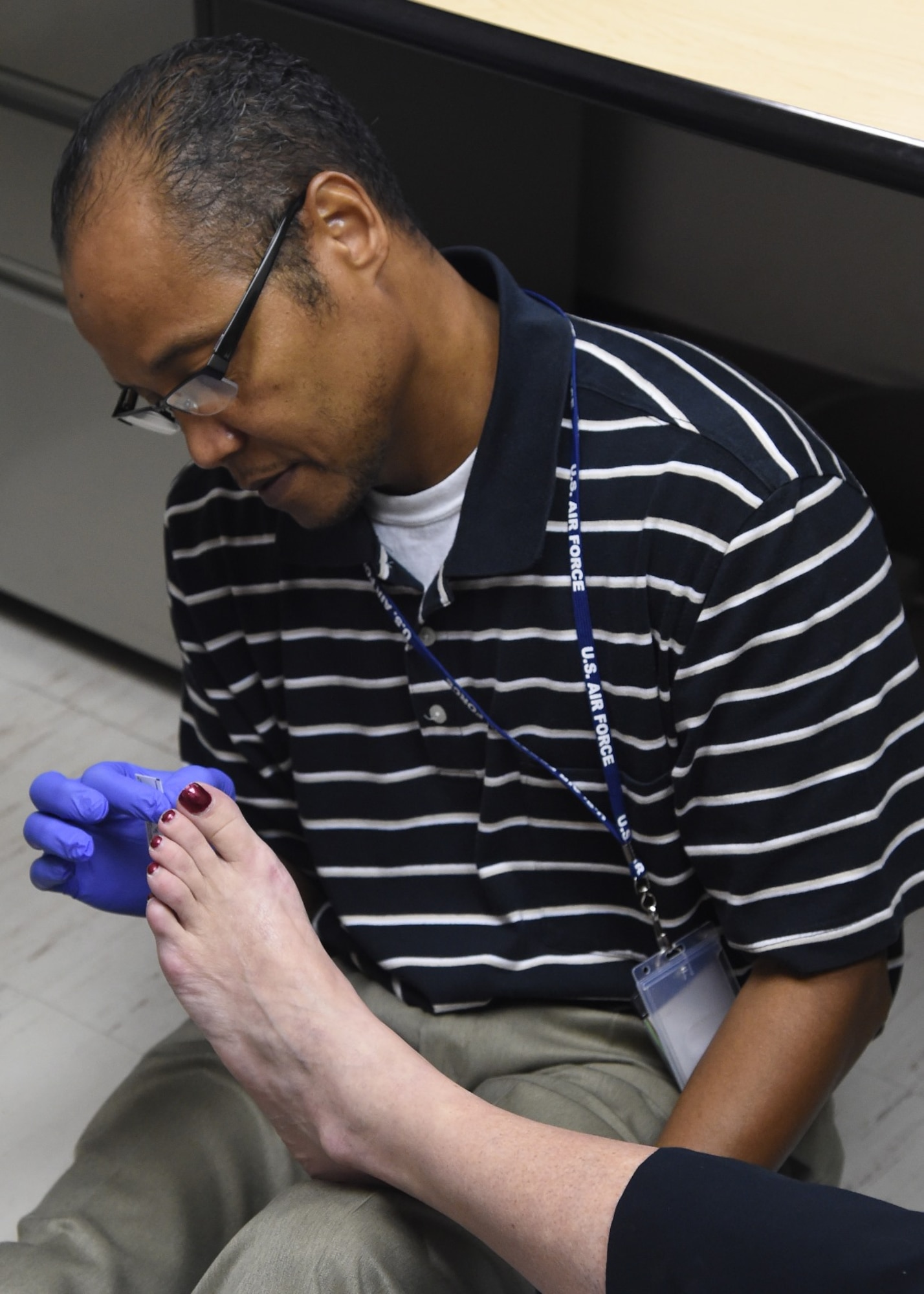 Donald Cobb, Diabetes Center of Excellence, does a foot examination on a patient Oct. 13, 2015, at the Wilford Hall Ambulatory Surgical Center, Joint Base San Antonio-Lackland. The clinical division provides referral care to more than 50,000 TRICARE beneficiaries. Within the clinical division, there are multiple areas of expertise to include prevention of diabetes, education for diabetes and patient management. 