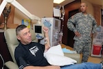 Army Spc. John Chase undergoes kidney dialysis treatment Sept. 23, 2011 at a dialysis center Grand Forks, N.D., as Army Sgt. Francisco Raatz looks on. Both Soldiers are members of the 1st Battalion, 188th Air Defense Artillery Regiment, of the North Dakota Army National Guard. Raatz would soon be donating a kidney to his battle buddy as a result of Chase's kidneys failing him about 17 months earlier.