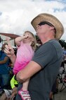 Patrick Alberts points out an aircraft to his daughter, Madisyn, during the 2015 Joint Base San Antonio Air Show and Open House Nov. 1, 2015 at JBSA-Randolph, Texas. Air shows allow the Air Force to display the capabilities of our aircraft to the American taxpayer through aerial demonstrations and static displays and allowing attendees to get up close and personal to see some of the equipment and aircraft used by the U.S. military today. (U.S. Air Force photo by Johnny Saldivar) 
