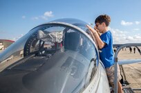 Brady Hoffmeyer looks inside the cockpit of a T-38 during the 2015 Joint Base San Antonio Air Show and Open House Nov. 1, 2015 at JBSA-Randolph, Texas. Air shows allow the Air Force to display the capabilities of our aircraft to the American taxpayer through aerial demonstrations and static displays and allowing attendees to get up close and personal to see some of the equipment and aircraft used by the U.S. military today. (U.S. Air Force photo by Johnny Saldivar) 
