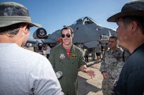 First Lieutenant Randall Ott, 303rd Fighter Squadron attack pilot, discusses an A-10 Thunderbolt II during the 2015 Joint Base San Antonio Air Show and Open House Oct. 31, 2015 at JBSA-Randolph, Texas. Air shows allow the Air Force to display the capabilities of our aircraft to the American taxpayer through aerial demonstrations and static displays and allowing attendees to get up close and personal to see some of the equipment and aircraft used by the U.S. military today. (U.S. Air Force photo by Johnny Saldivar) 
