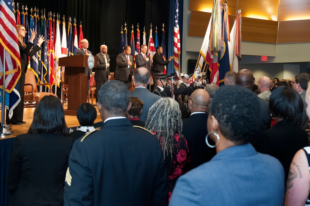 Audience and participants stand during the singing of the national anthem as part of the Defense Department’s 35th Annual Disability Awards Ceremony at the Pentagon, Oct. 29, 2015. DoD photo by Marvin Lynchard