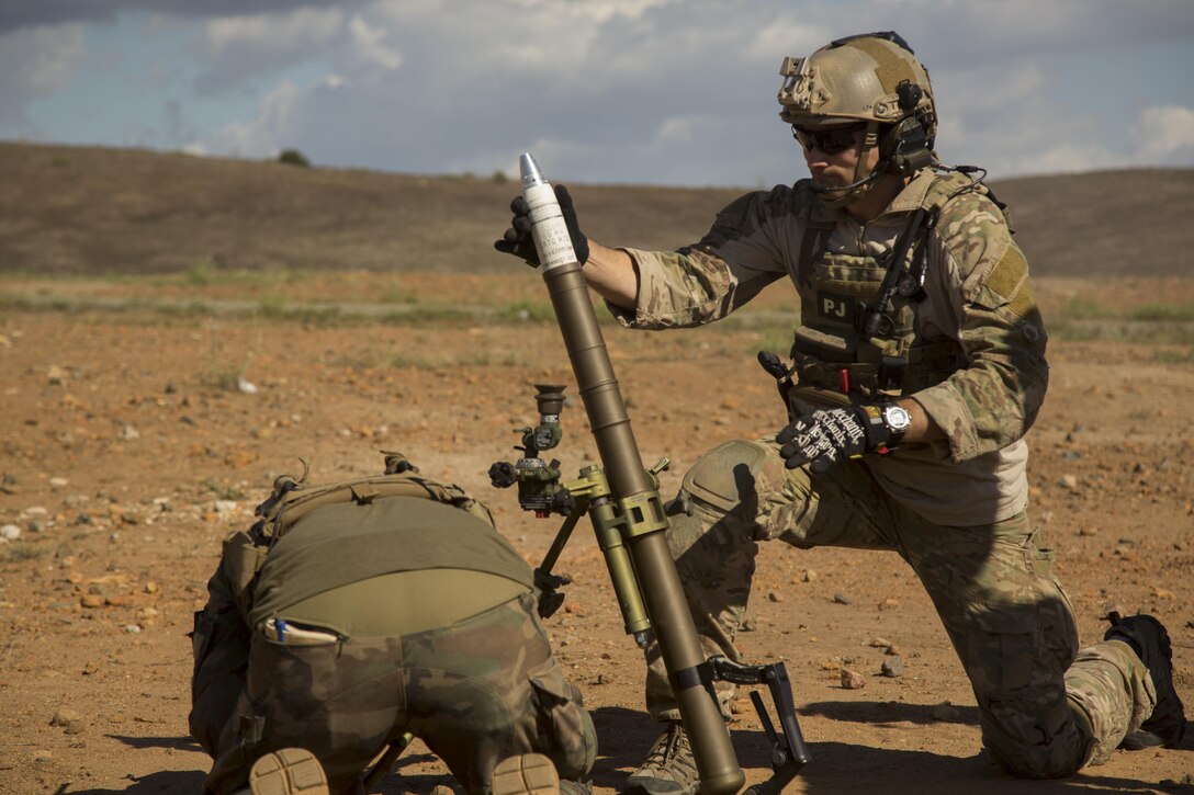 A U.S. Air Force Pararescue Jumper prepares to fire a 60 mm mortar round during a Company Collective Exercise aboard Marine Corps Base Camp Pendleton, Calif., Oct. 7, 2015. Marine Special Operations Company C, 1st Marine Raider Battalion, U.S. Marine Corps Forces, Special Operations Command spent the first phase of their three-phase Company Collective Exercise practicing Foreign Internal Defense aboard Marine Corps Base Camp Pendleton, Calif., Oct. 5-8.