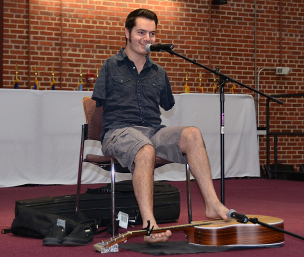 National recording artist George Dennehy shares his experience of growing up without arms during his performance as part of the National Disability Employment Awareness Month program at the Lotts Conference Center on Defense Supply Center Richmond, Virginia, Oct. 19, 2015.