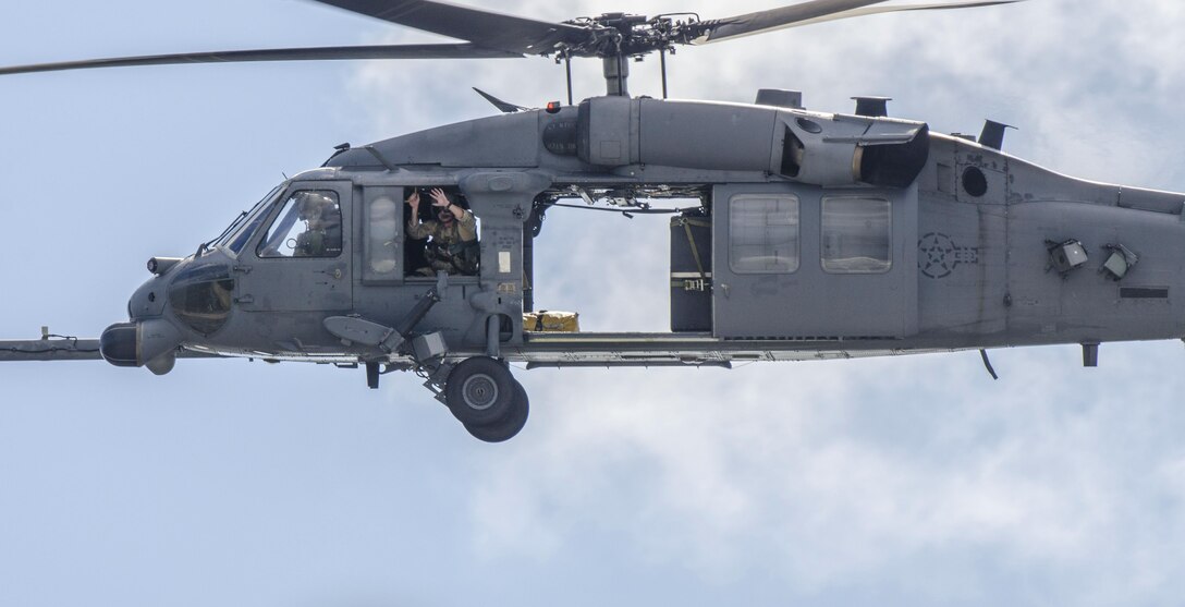 Air Force Reservists from the 920th Rescue Wing, Patrick Air Force Base, Florida, return after patrolling and clearing the Eastern Range in two HH-60G Pave Hawk helicopters. The Airmen ensured the Range was safe and secure prior to a United Launch Alliance Atlas V rocket launch carrying a Boeing-built Global Positioning System IIF satellite from Space Launch Complex 41, Cape Canaveral Air Force Station Oct. 31. Airmen from the 920th RQW are responsible for clearing and securing the Eastern Rocket Range prior to all Space Coast rocket launches. (U.S. Air Force photo/Maj. Cathleen Snow)