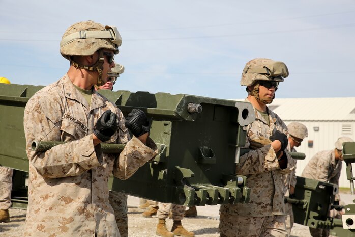 Marine students in the 8th Engineer Support Battalion Bridge Master’s Course carry a bridge part during a practical application of recently learned skills at Camp Lejeune, N.C., Oct. 29, 2015. Marines worked together to carry bridge parts weighing between 400 and 600 pounds.  (U.S. Marine Corps photo by Cpl. Paul S. Martinez/Released)