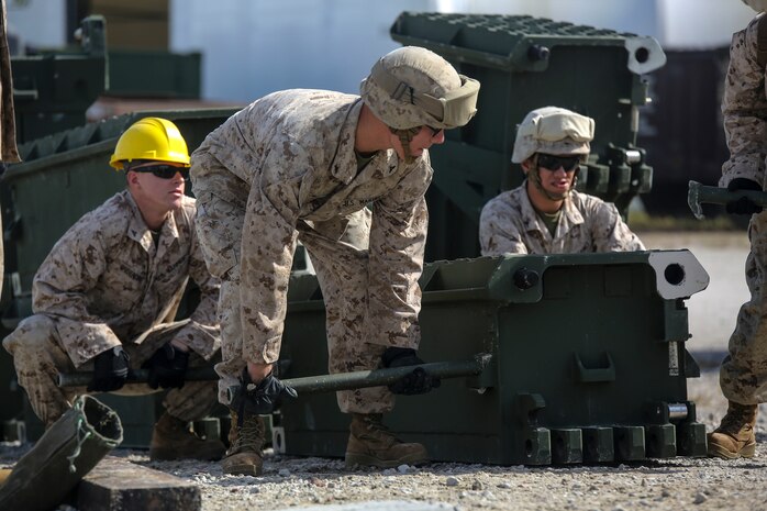 Marine students in the 8th Engineer Support Battalion Bridge Master’s Course prepare to lift a bridge part during a practical application of recently learned skills at Camp Lejeune, N.C., Oct. 29, 2015. The course teaches Marines to lead the bridge building process, and is hosting Marines from 9th Engineer Support Battalion, 3rd Marine Logistics Group, based out of Camp Hansen, Okinawa. (U.S. Marine Corps photo by Cpl. Paul S. Martinez/Released)