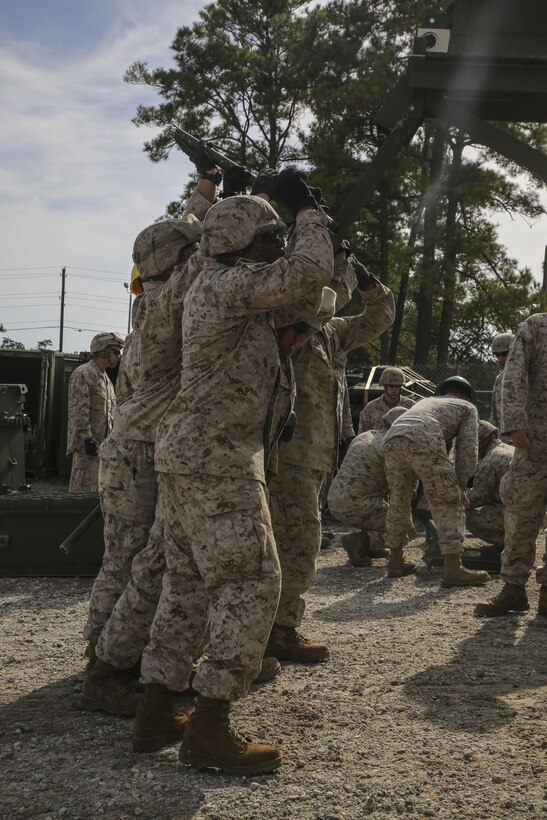 Marine students in the 8th Engineer Support Battalion Bridge Master’s Course connect bridge foundation parts during a practical application of recently learned skills at Camp Lejeune, N.C., Oct. 29, 2015. The course teaches Marines to lead the bridge building process, and is hosting Marines from 9th Engineer Support Battalion, 3rd Marine Logistics Group, based out of Camp Hansen, Okinawa. (U.S. Marine Corps photo by Cpl. Paul S. Martinez/Released)