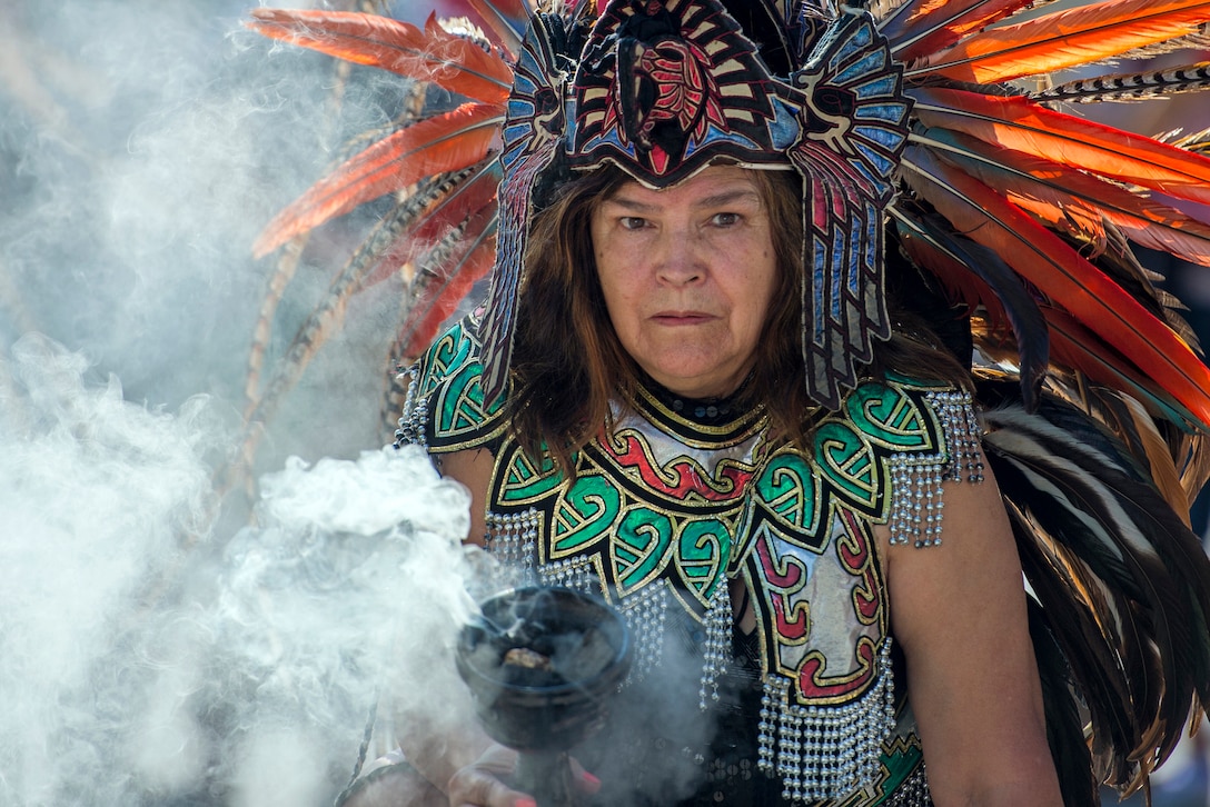 An Aztec healer holds a cauldron of cleansing smoke during a dance performance at the annual Latino Heritage Festival in Des Moines, Iowa, Sept. 26, 2015. DoD photo by EJ Hersom