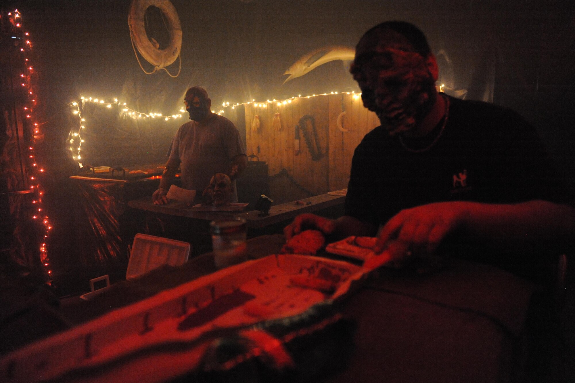 Volunteers act out a scary scene for visitors of the haunted house during Ghouls in the Park at marina park, Oct. 30, 2015, Keesler Air Force Base, Miss. Ghouls in the Park also featured games with prizes and “Trunk or Treat”.  (U.S. Air Force photo by Kemberly Groue)