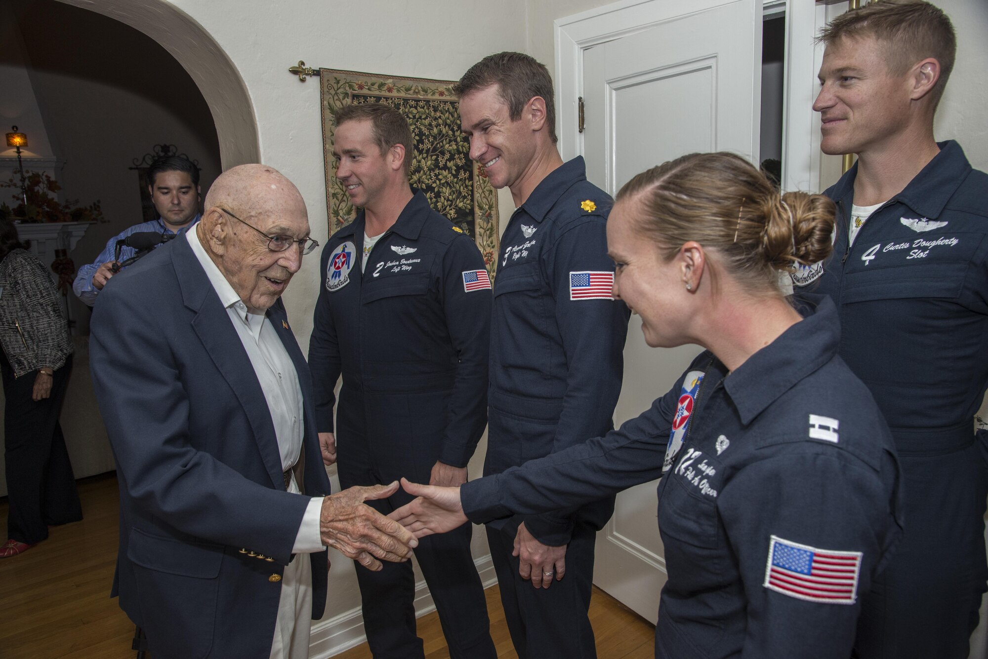 Retired Lt. Col. Richard Cole, Doolittle Raider, shakes hands with members of the U.S. Air Force Thunderbirds at his 100th birthday celebration Oct. 30, 2015, at Joint Base San Antonio-Randolph. The Doolittle Raiders were a group of 80 men who served under the command of Gen. James “Jimmy” Doolittle.  The Raiders conducted a bombing mission on Japan April 18, 1942, in retaliation for the attack on Pearl Harbor. (U.S. Air Force photo by Airman 1st Class Stormy Archer/Released)