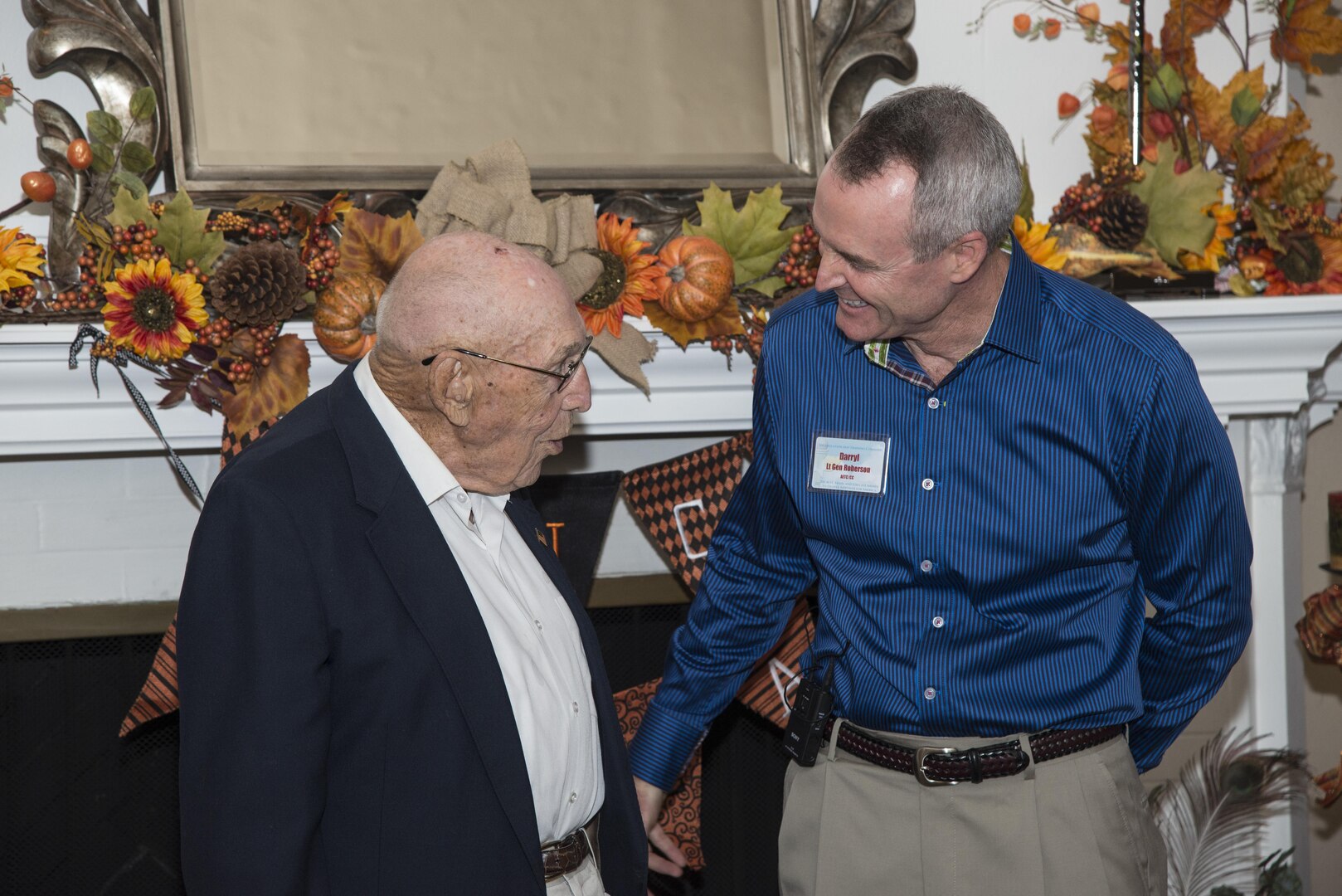 Retired Lt. Col. Richard Cole, Doolittle Raider, speaks with Lt. Gen. Darryl Roberson, commander of Air Education and Training Command, during his 100th birthday celebration Oct. 30, 2015, at Joint Base San Antonio-Randolph. The reception afforded General Roberson and attendees an opportunity to interact with an individual who represents a linkage to Air Force heritage.  The event also bridged the past and present, and offered Airmen a chance to interact with a living legend. (U.S. Air Force photo by Airman 1st Class Stormy Archer/Released)