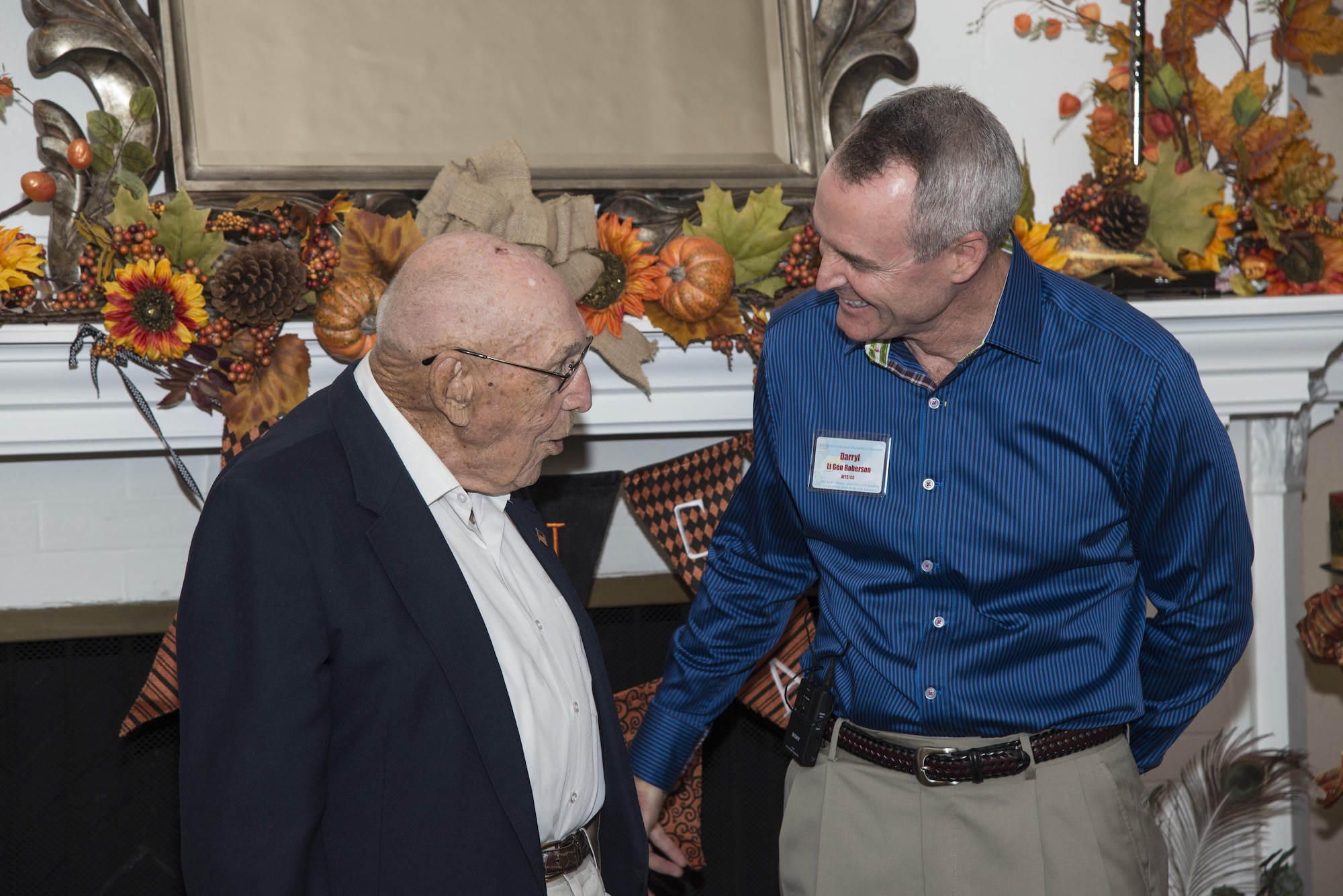 Retired Lt. Col. Richard Cole, Doolittle Raider, speaks with Lt. Gen. Darryl Roberson, commander of Air Education and Training Command, during his 100th birthday celebration Oct. 30, 2015, at Joint Base San Antonio-Randolph. The reception afforded General Roberson and attendees an opportunity to interact with an individual who represents a linkage to Air Force heritage.  The event also bridged the past and present, and offered Airmen a chance to interact with a living legend. (U.S. Air Force photo by Airman 1st Class Stormy Archer/Released)